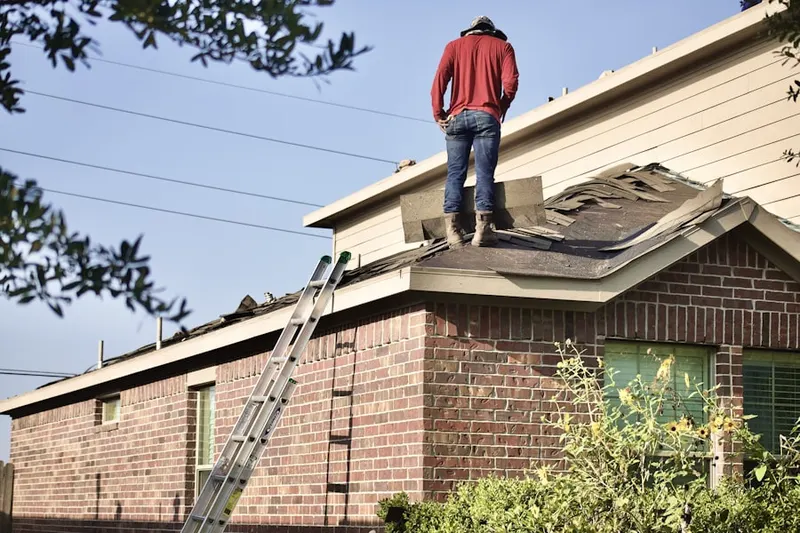 Professional roofer working on a residential roof in Rancho West